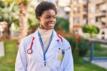 African american woman wearing doctor uniform standing at park