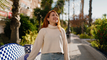 Young redhead woman smiling confident standing at park