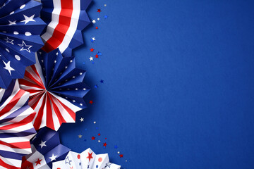Paper fans in color of American flag and confetti on dark blue background. USA Labor Day,...