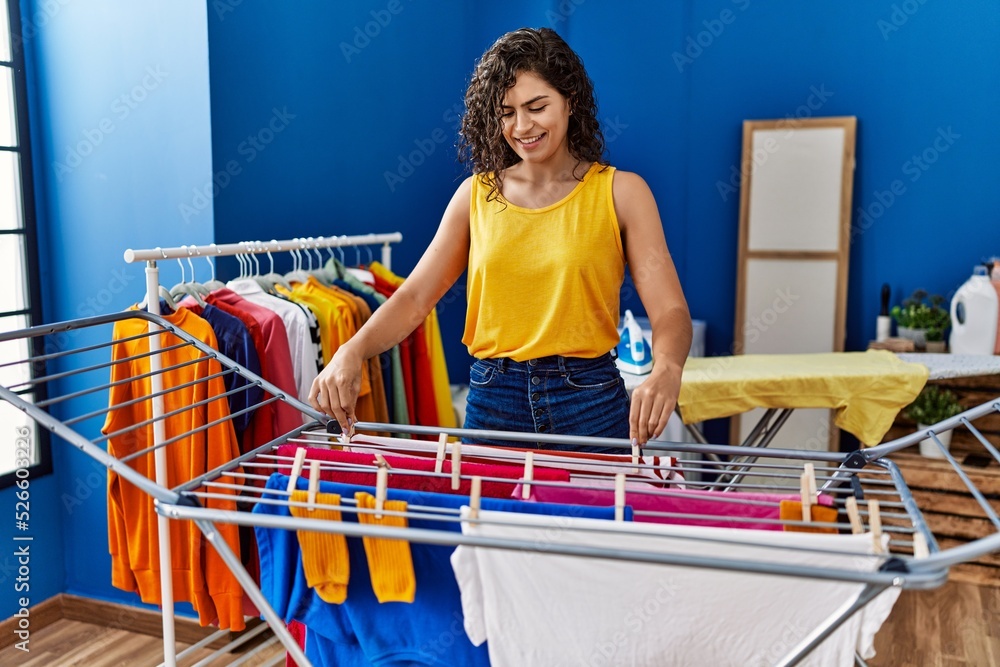 Canvas Prints young latin woman smiling confident hanging clothes on clothesline at laundry room - Canvas Prints