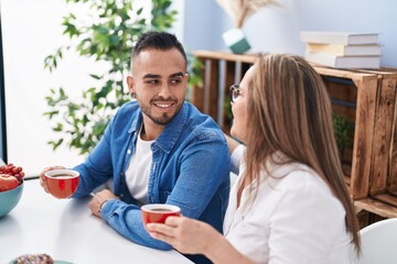 Man and woman mother and son drinking coffee at home