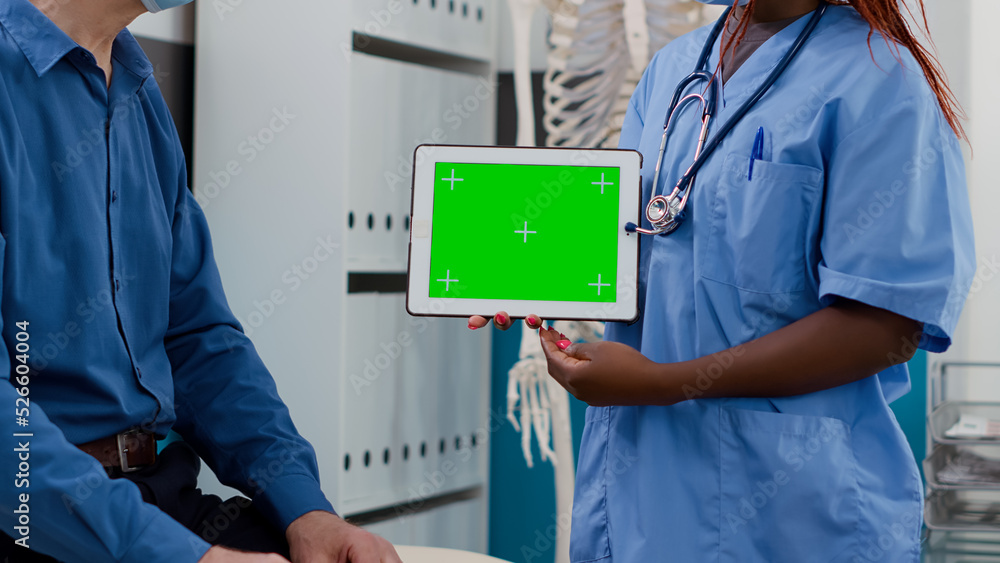 Poster specialist holding horizontal greenscreen on tablet at checkup with elderly patient. using blank moc