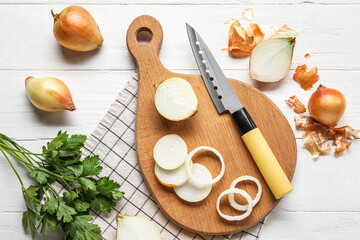 Composition with fresh onion and parsley on light wooden background