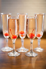 a glass of champagne wine with a cherry inside
