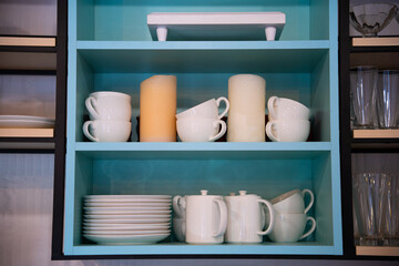 Fototapeta na wymiar kitchen utensils on the shelf in the closet