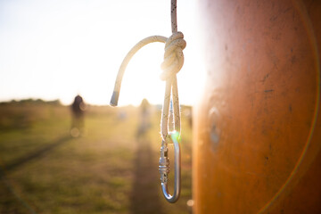 a rock climber's carabiner on a lanyard in a beautiful backlight