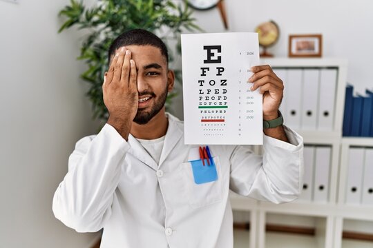 Young arab man holding sneller test at clinic