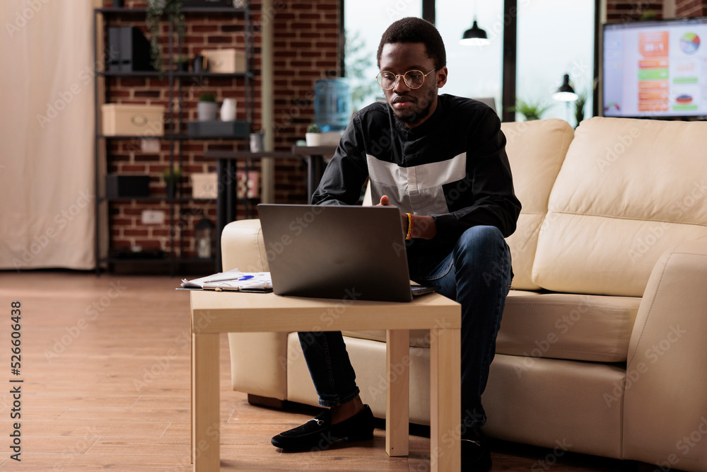 Aufkleber african american employee working on laptop to plan business presentation and new software developin