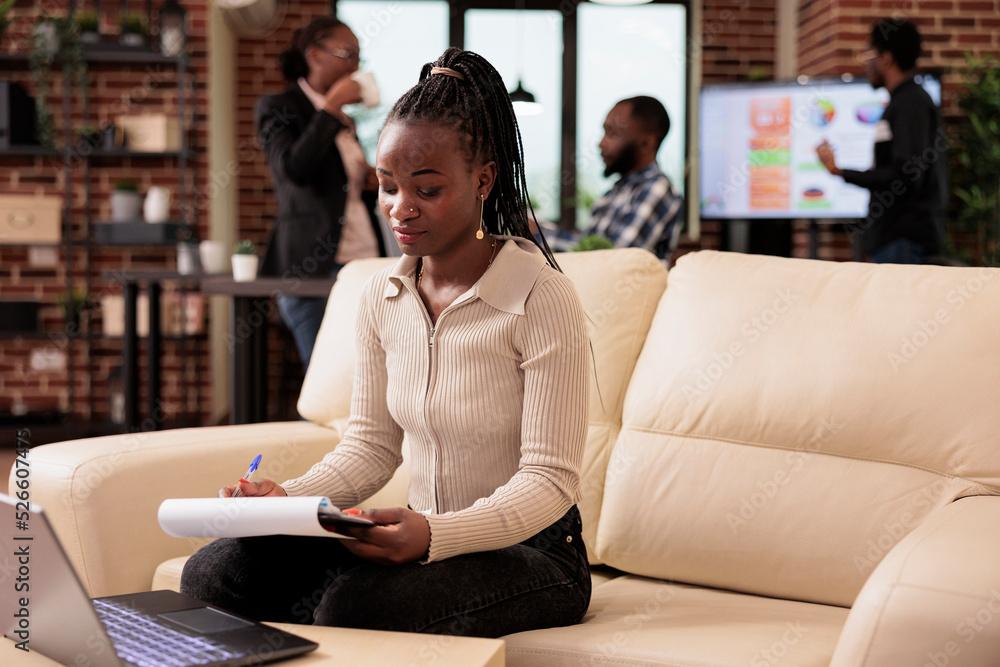 Poster african american woman working on report files to send email and plan business presentation on lapto