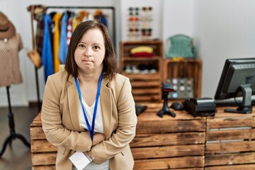 Young down syndrome woman working as manager at retail boutique with hand on stomach because nausea, painful disease feeling unwell. ache concept.