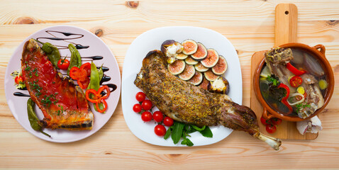 Top view of set of assorted lamb dishes on wooden table