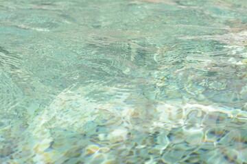 Rippled water in swimming pool as background