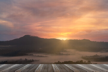 sunrise on the fog city, the mist of city, view from top of moutain. The sun, the fog, rays through the houses and the pines