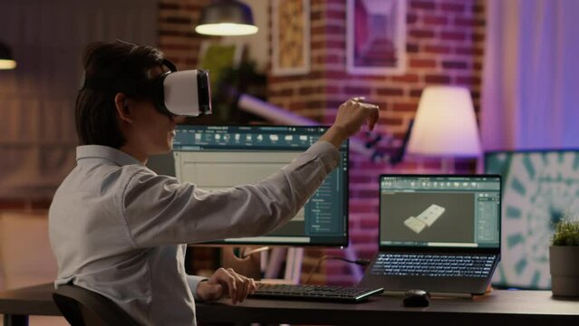 Asian technician using vr glasses and industrial software to create advanced manufactory product on blueprint. Working with augmented reality headset to develop machinery engine on computer.
