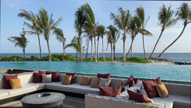 Maldivian island lounge bar on the coast.
Blue cyan water pool, ocean sea view.
Horizon paradise vacation trip background.
