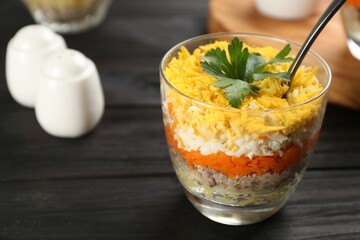 Traditional russian salad Mimosa served on dark wooden table. Space for text