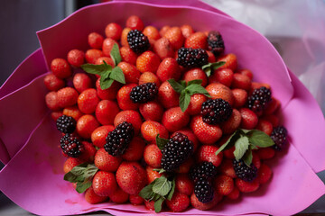 Delicious bouquet of strawberries and roses. Close up.