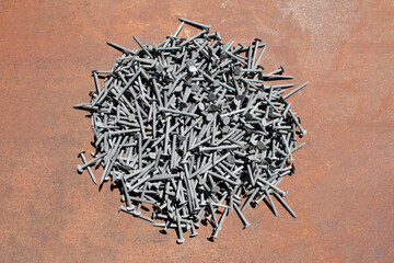 steel nails iron overhead table nail pile background studio working building supply materials...