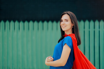 Confident Beautiful Woman Wearing a Superhero Red Cape. Strong super heroine feeling self-confident...