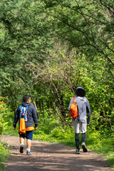 two young men and friends descending in the ravine, vegetation and trees, huentitan ravine guadalajara, mexico