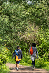 two young men and friends descending in the ravine, vegetation and trees, huentitan ravine guadalajara, mexico