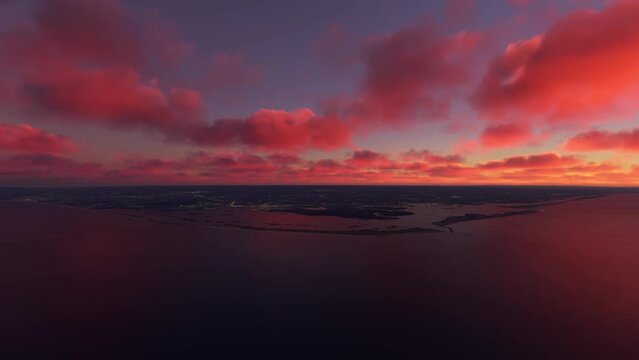Aerial view flying over the City of Faro at sunset in Portugal. Landscape of the coast and beaches of Portugal