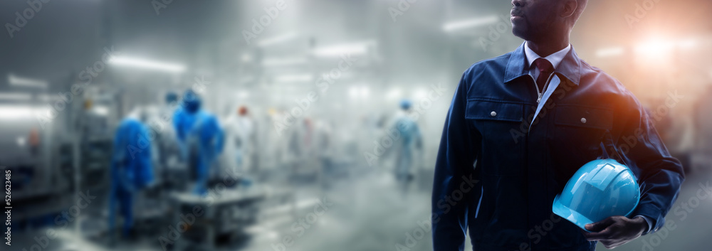 Poster engineer standing in factory. wide image for banners, advertisements.