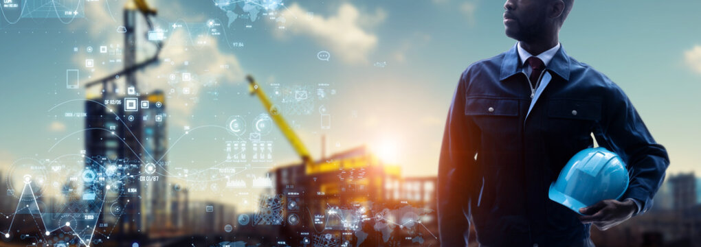 An engineer standing at a construction site and a digital data concept. Wide image for banners, advertisements.