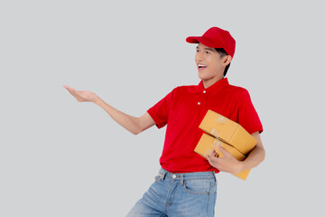 Young asian man in uniform red and cap standing carrying box stack isolated white background, employee holding cargo or package, courier and delivery, transportation and service, logistic concept.