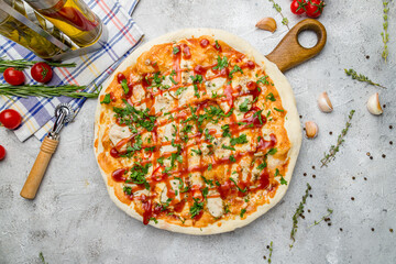 Pizza with chicken and barbecue sauce on grey table top view