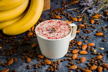 Raf coffee with raspberry and lavender with banana milk on grey table