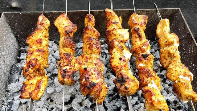 Close-up of cooking food on the barbecue. The process of grilling kebabs.