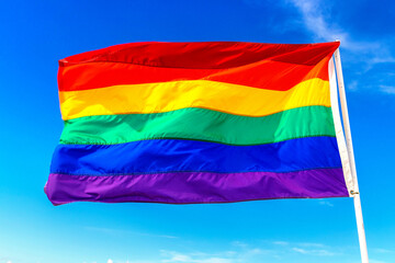 Rainbow LGBT gay flag against sky