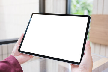 Mockup image of a woman holding digital tablet with blank white desktop screen