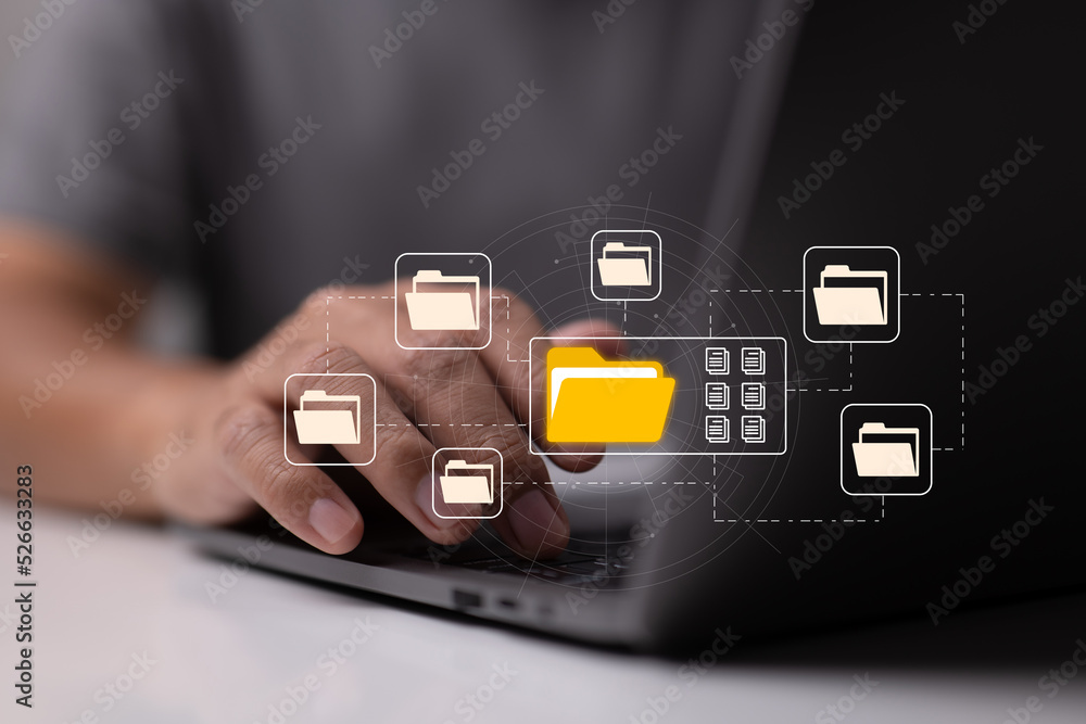 Aufkleber e-documents enable paperless offices. a businessman types on a laptop while examining virtual docume