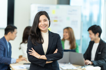 Business people showing team work while working in board room in office interior. People helping one of their colleague to finish new business plan. Business concept. Team work.