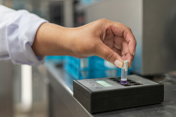 Hand of a woman working with samples in a laboratory of a dairy factory