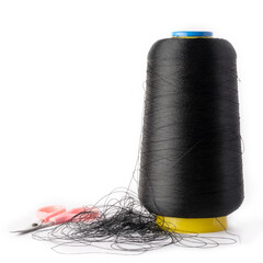 spool of black color sewing thread used in fabric and textile industry with an embroidery pair of scissors,  isolated on white background