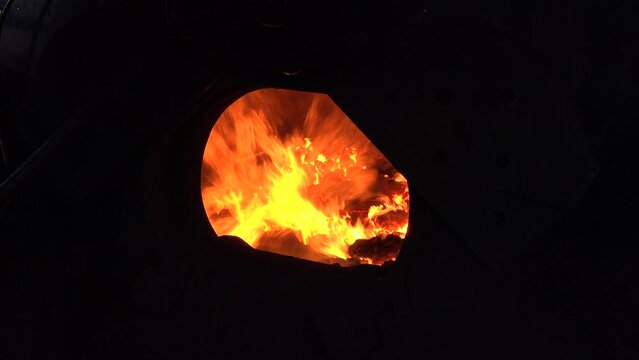 Coal fire in boiler of train burning with intensity in front engine of steam train England UK 4K Yorkshire