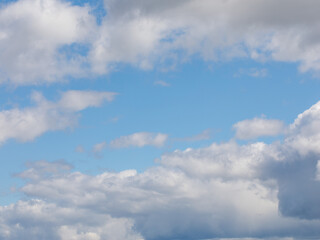 Blue sky and white big Cumulus clouds abstract background. The light of day in the sky. The composition of the natural sky. Design element. Copy space
