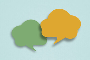 two blank speech bubble paper cut,  on grunge green paper background. Conceptual image about communication and social media