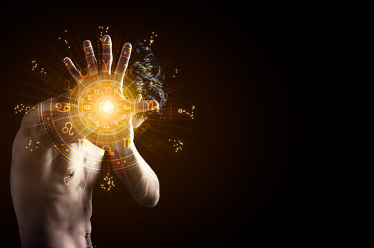 A man showing stop hands with the hands have astrological symbols.