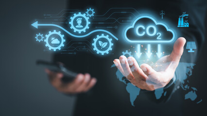 Industrial emissions pollute the environment and ecosystems. including climate change, Carbon Renewable Energy Agreement, reducing greenhouse gas emissions,businessman holding an icon in his hand