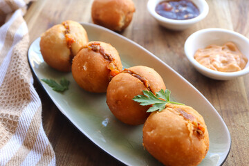 Vetkoek with mince curry. Traditional South African snack made with fried dough usually filled with curry or jam