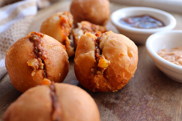 Vetkoek with mince curry. Traditional South African snack made with fried dough and usually filled with curry or jam. Fat cakes or amagwinya 