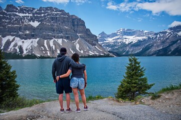 Fototapeta na wymiar Mature couple standing on the mountain lake shore