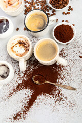 Coffee cup assortment on light background.