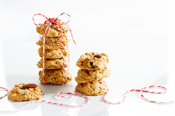 Oatmeal cookies with black sesame and almond with red and white color rope.