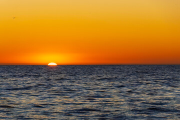 Amazing sunset on the Atlantic Ocean. The sun reflected in the waves