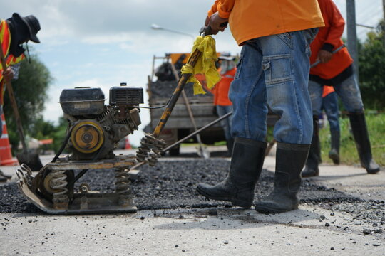 Blurred image of pavement repair work.